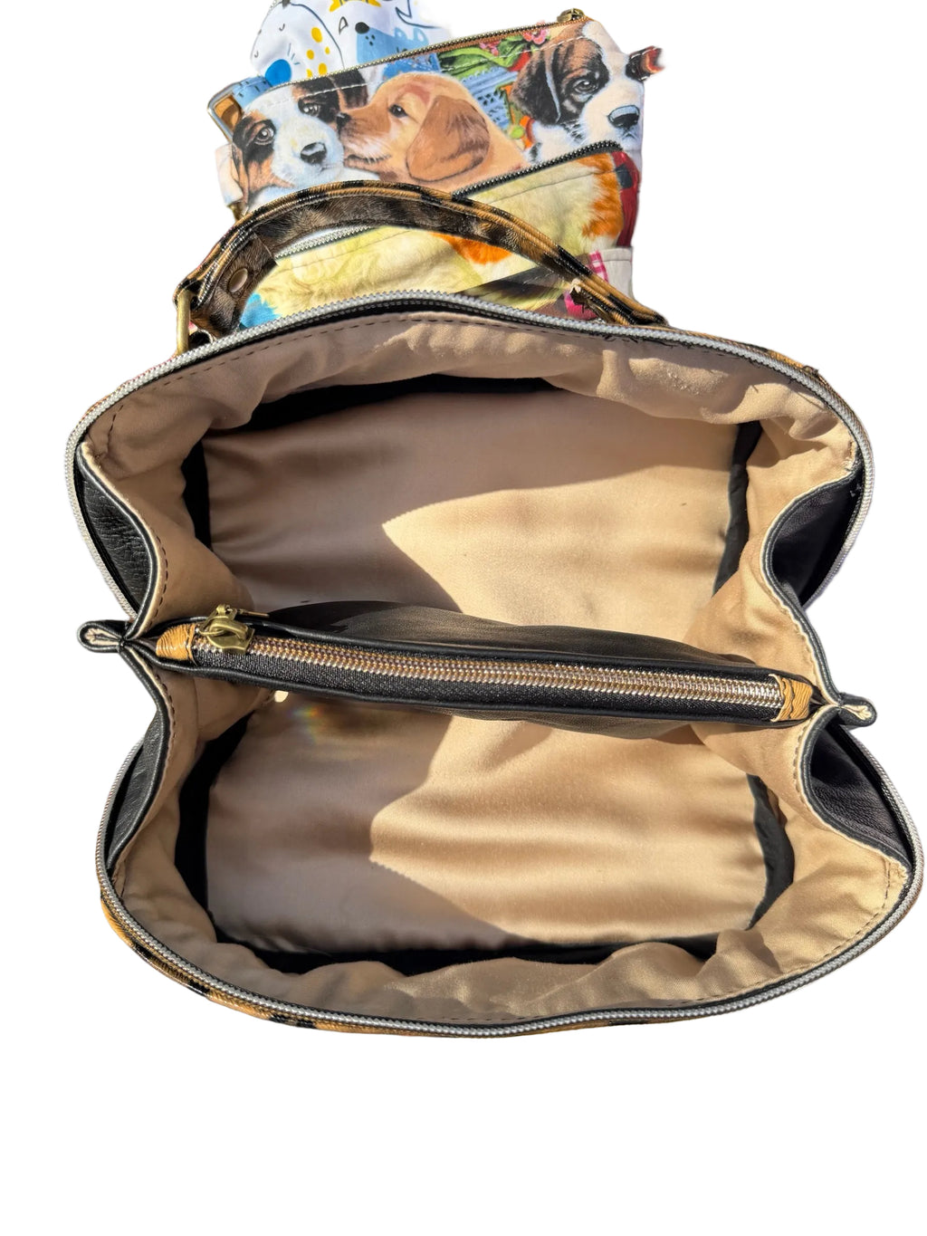 Lacarmenbags black faux leather handbag interior with champagne lining, zippered center compartment, and gold hardware